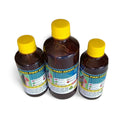 Three bottles of Hakki Pikki Hair Oil with yellow caps and detailed product labels
