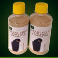 Two bottles of Hakki Pikki Adivasi shampoo with yellow caps and clear labels showing hair care branding