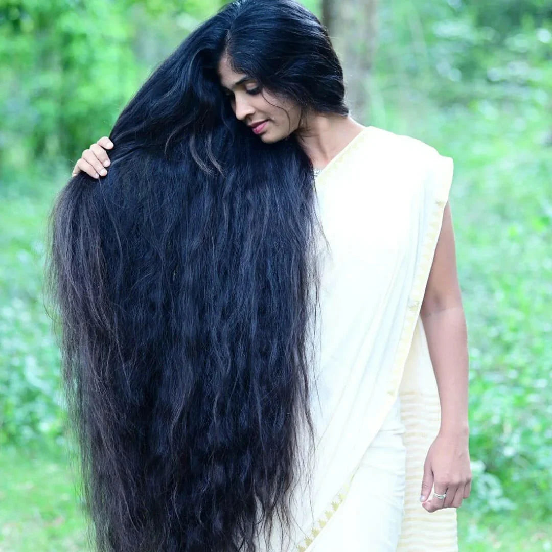Woman with long thick black hair showcasing effects of Hakki Pikki shampoo and hair oil